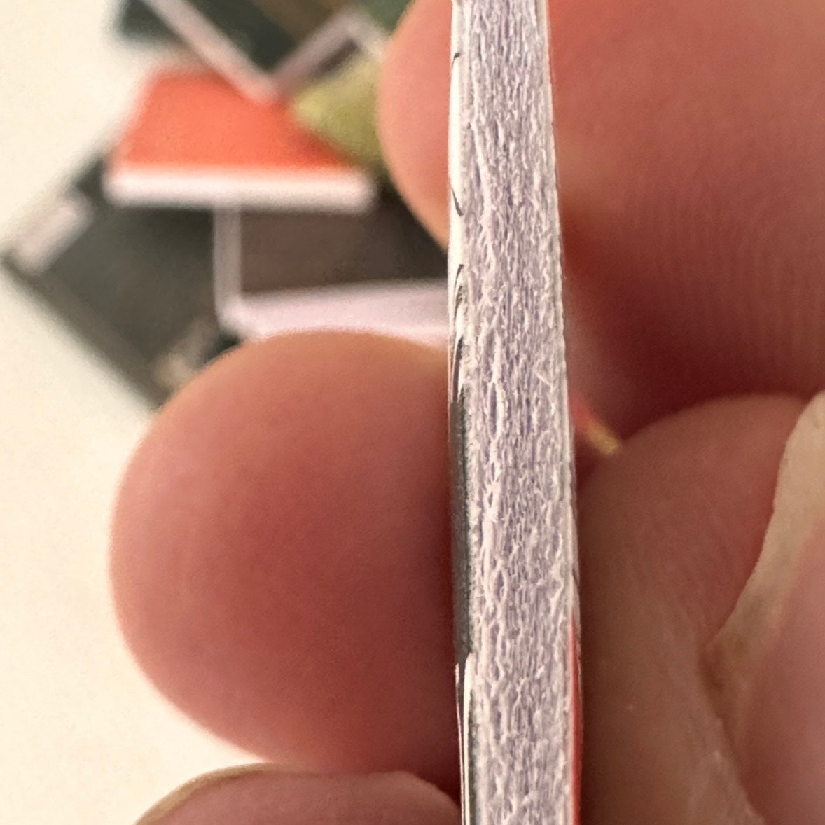 Close-up of book held between fingers 